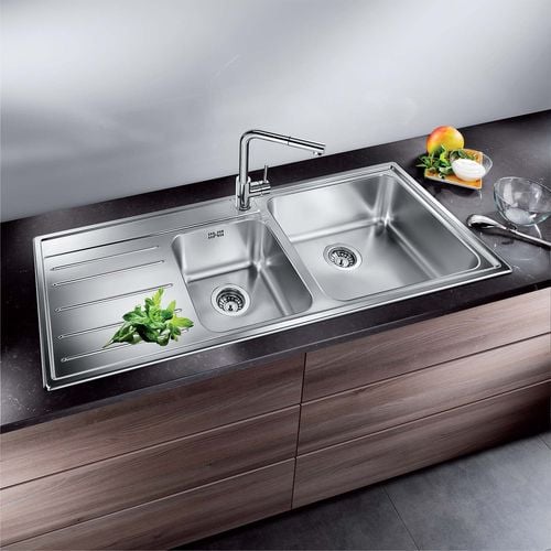 Sink with two basins built into a black kitchen benchtop