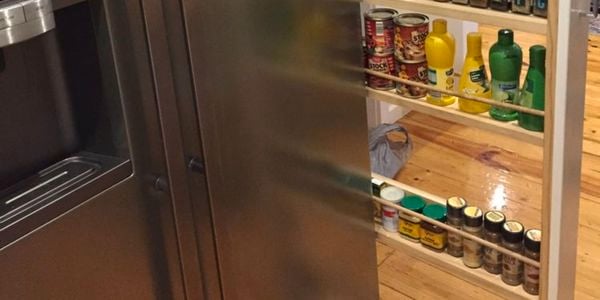A pull-out spice rack in a kitchen