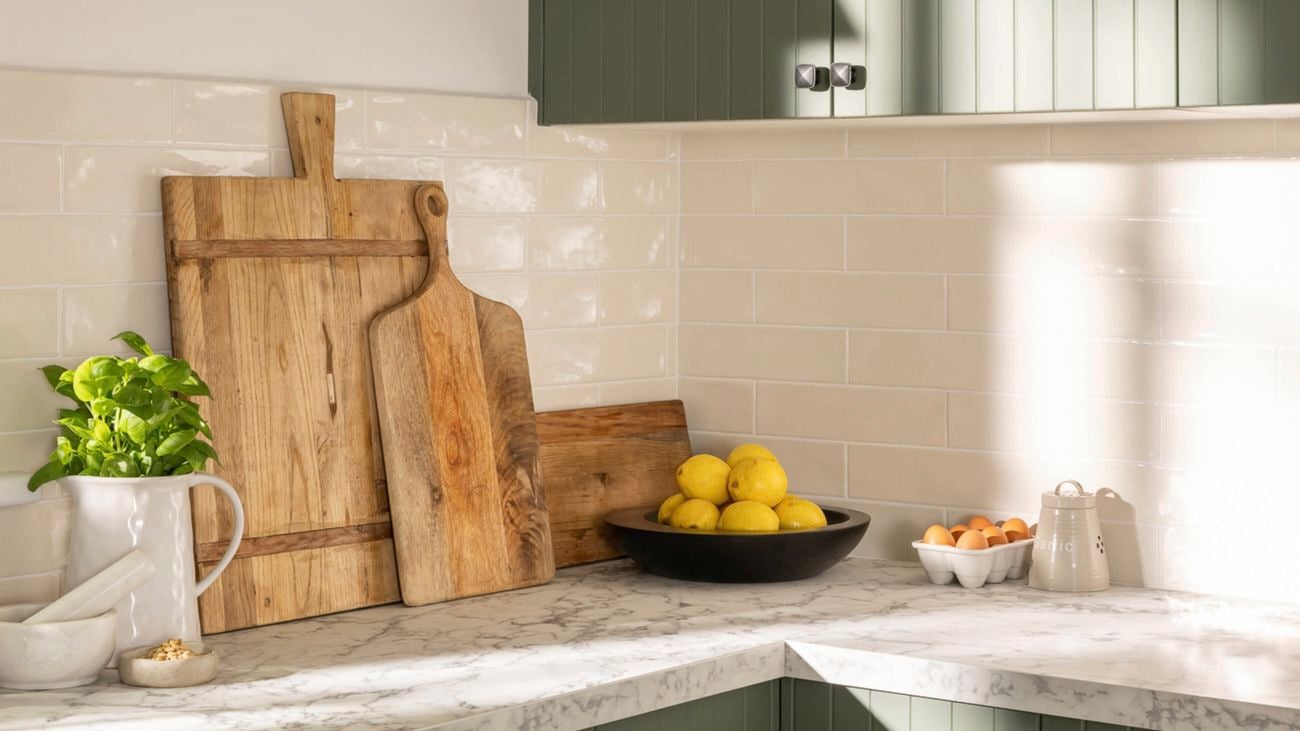 Corner of the green kitchen with chopping boards in up right position