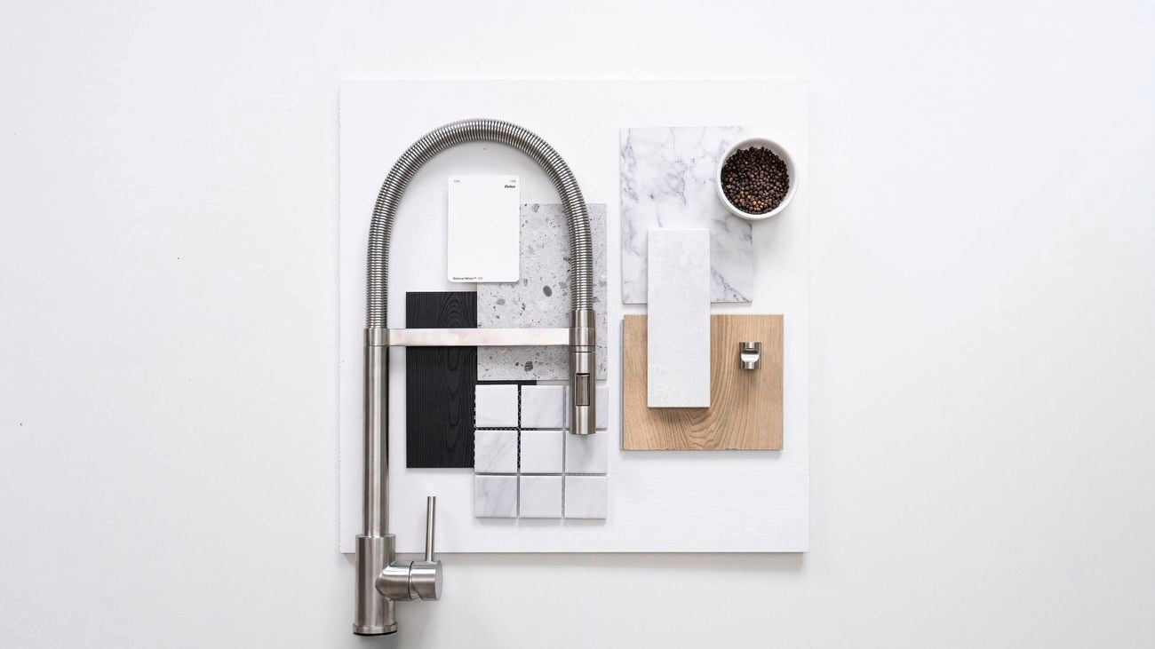Mid Century Modern kitchen flatlay with a stainless steel tap, marble, terrazzo, wood, and monochrome tiles