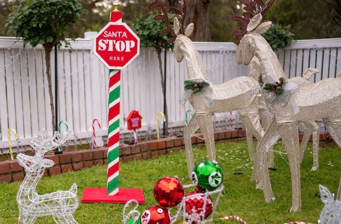 Santa stop here sign sitting on grass front lawn