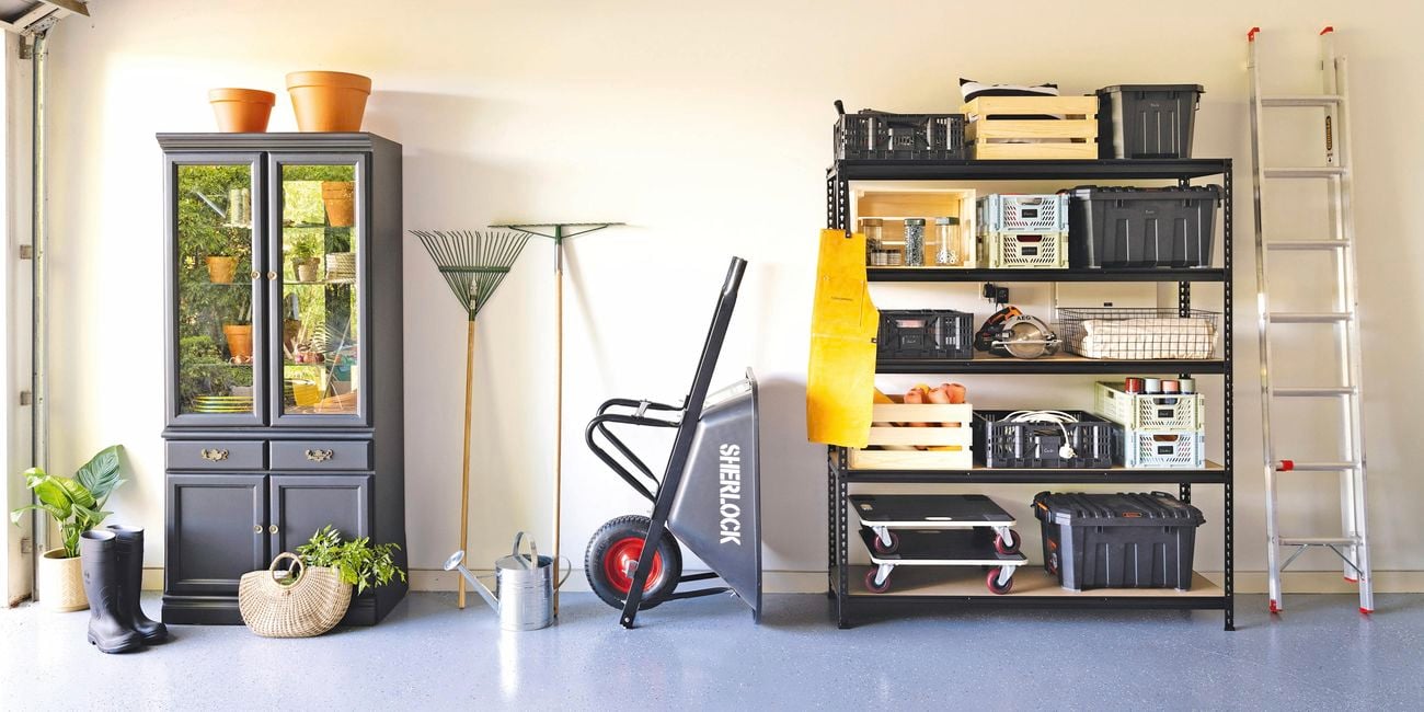 An organised garage with shelving and a cabinet.