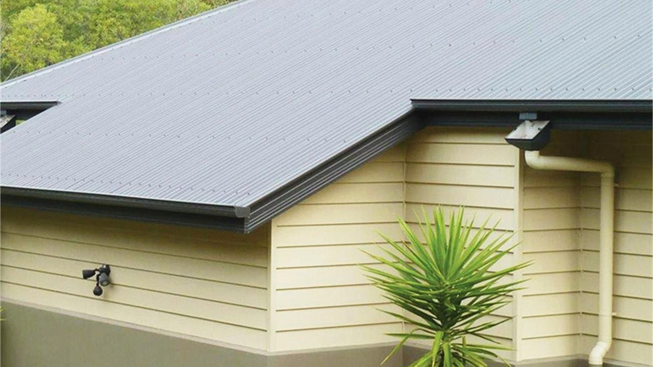 Grey roof with gutter and downpipe.