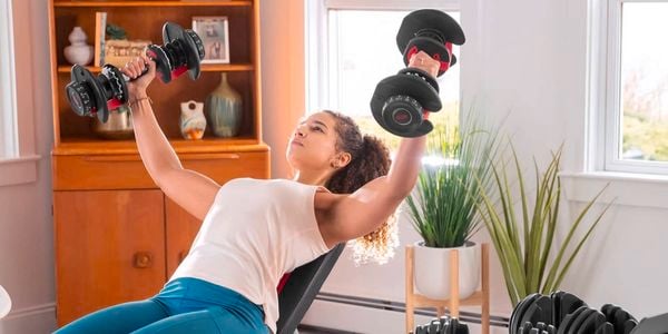 Woman lifting weights from Fitness lab