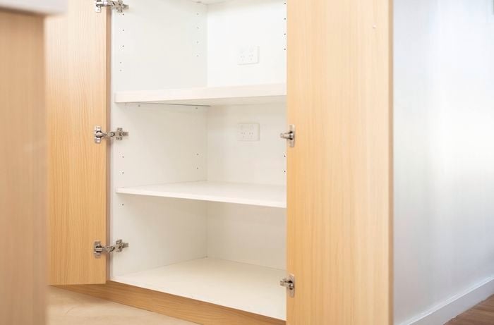 Open cupboard showing clear internal space for pull-out drawer measurements