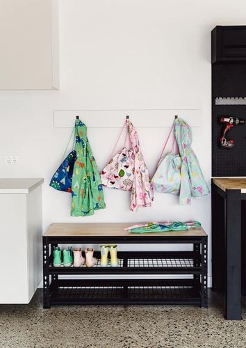 The Pinnacle Urban workbench used in a garage as seating and shoe storage.