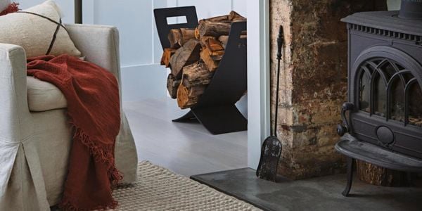 Fireplace with stack of wood.
