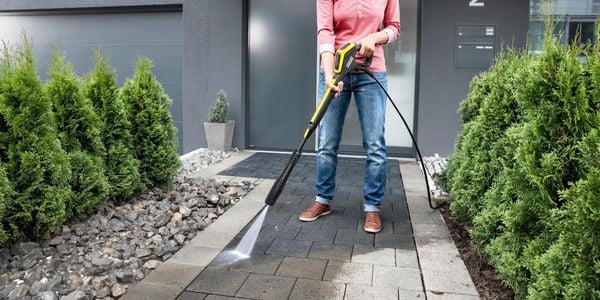 Woman washing her home entrance with Karcher Power Control