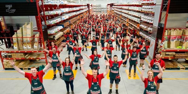 Image of team spread out in the timber yard for a photo of the team