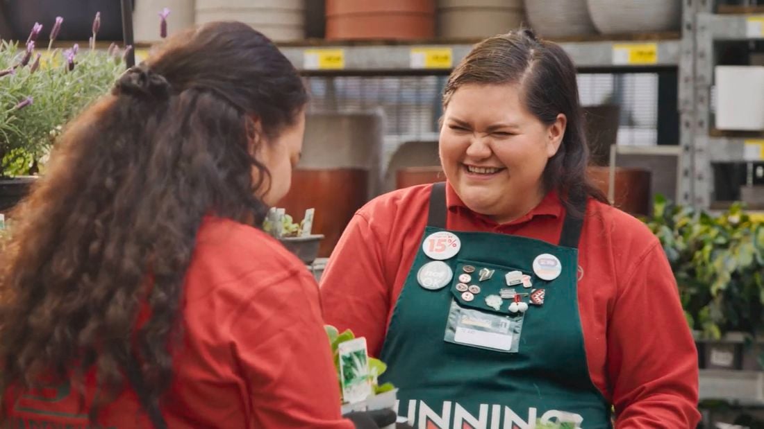 Team members in store laughing while working in the nursery
