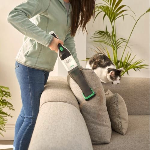Stick vac being used to clean floors