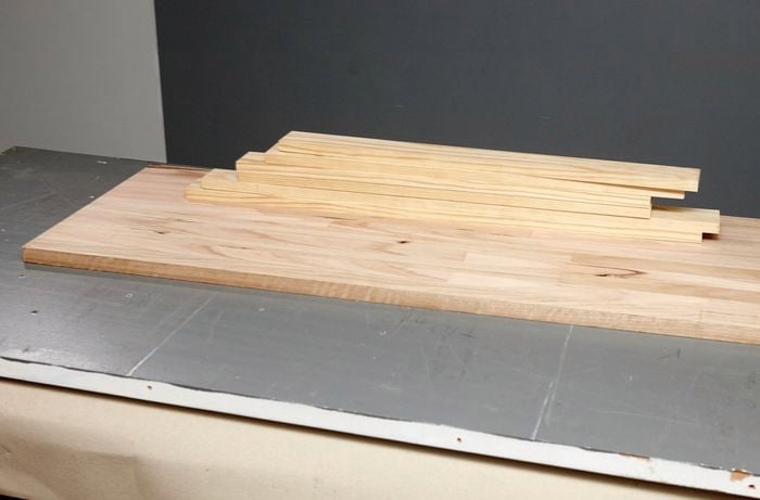 A composite timber table top and six lengths of pine timber