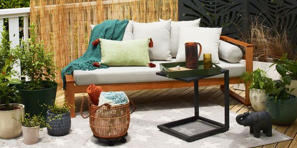 Fenced backyard with lawn, plants and outdoor barbeque