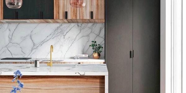Close up of Kaboodle marble-look kitchen benchtop, sink and brushed brass sink mixer