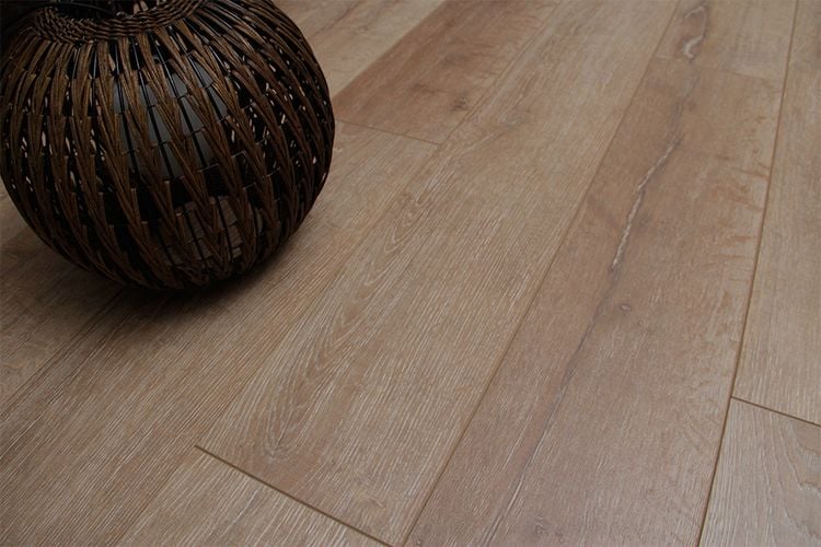 Close up of timber-look flooring with woven planter