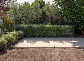 A prepared outdoor area features a leveled and compacted paver sand base 