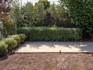 A prepared outdoor area features a leveled and compacted paver sand base 