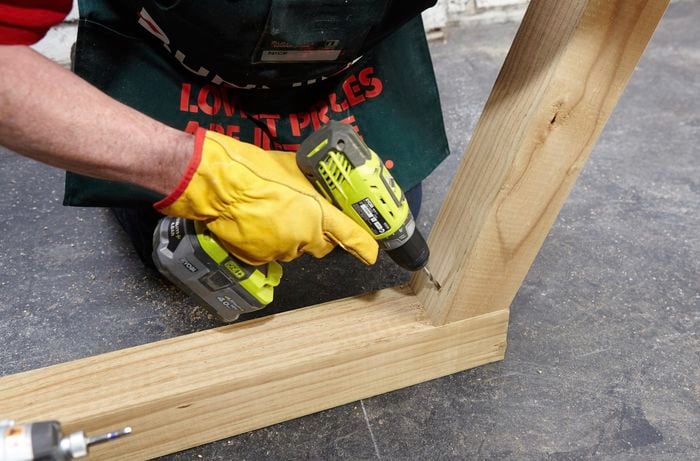 Person drilling into timber.