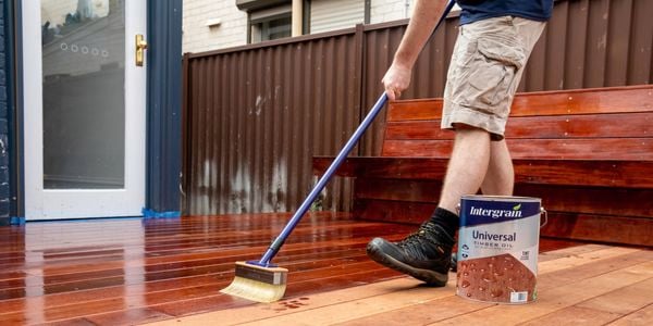 man oiling a deck