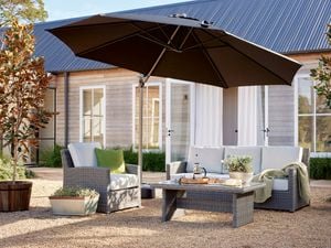 wicker outdoor setting in shot with umbrella