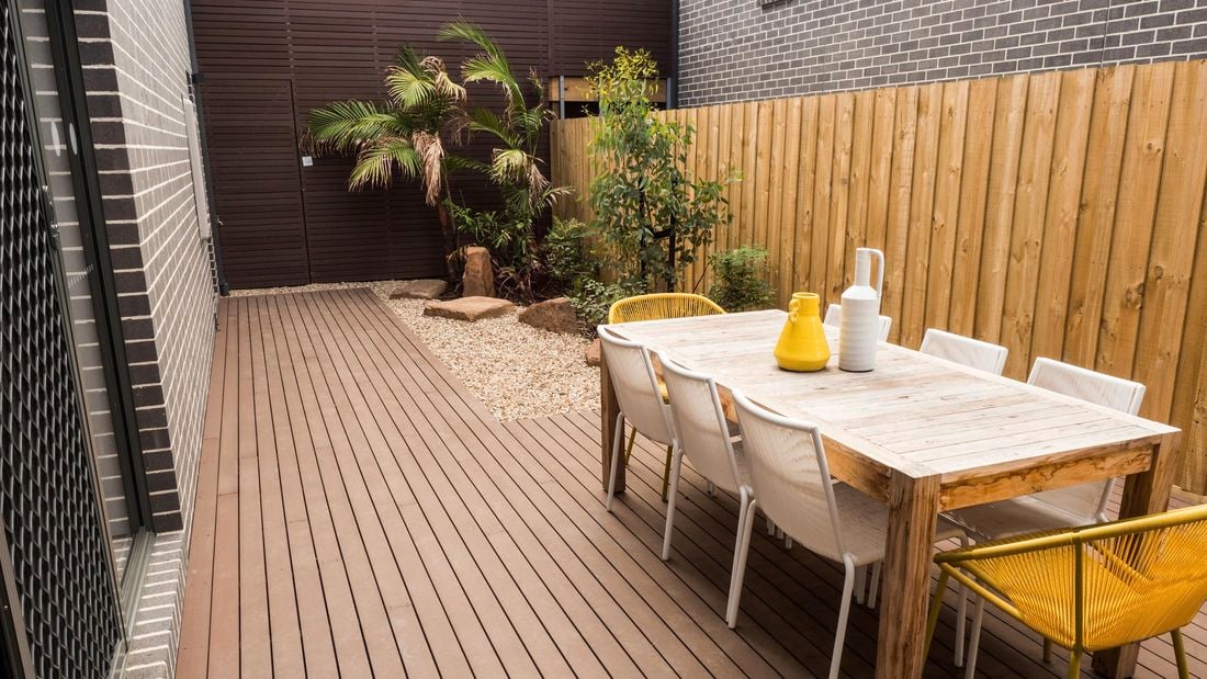 Outdoor furniture on a deck outside a townhouse