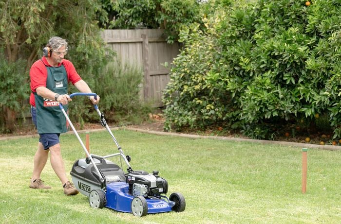 Team member mowing the lawn