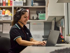 Bunnings team member sitting at her desk and working on her laptop