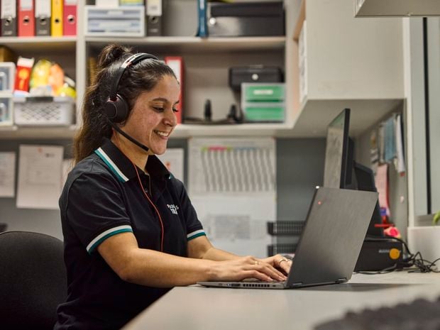 Bunnings team member sitting at her desk and working on her laptop