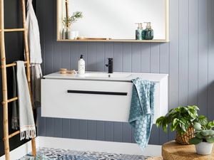 Modern grey bathroom featuring a mirror vanity.