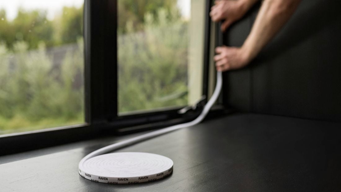 Person installing weather seals to window.