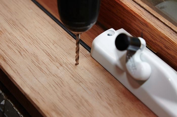 Drilling a hole in a windowsill for an awning window winder