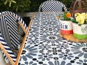 Potted succulent centrepiece on a tiled outdoor dining table