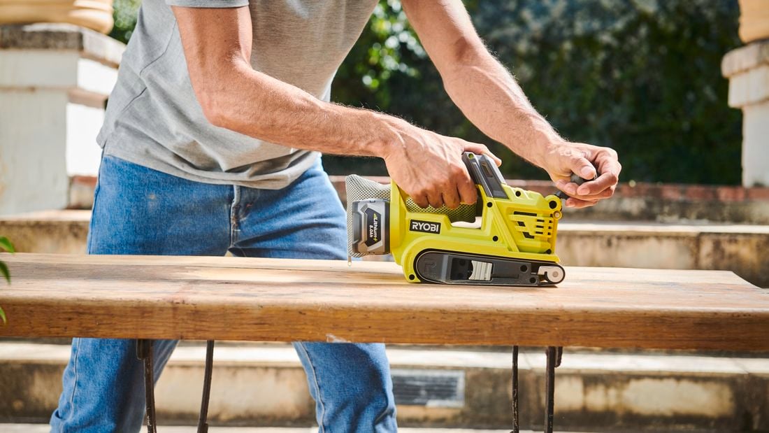 Man using Ryobi sander.