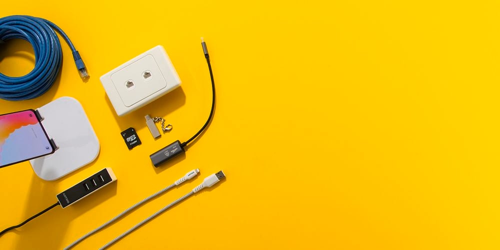 Bright yellow background with various phone/data products laid out on left side