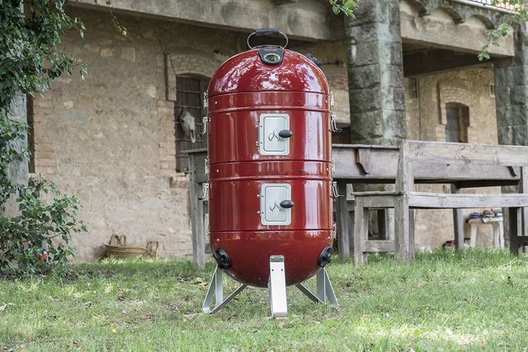 A red bullet smoker in an outdoor area