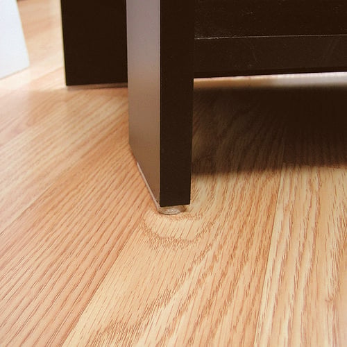 Cabinet base with adhesive floor protection