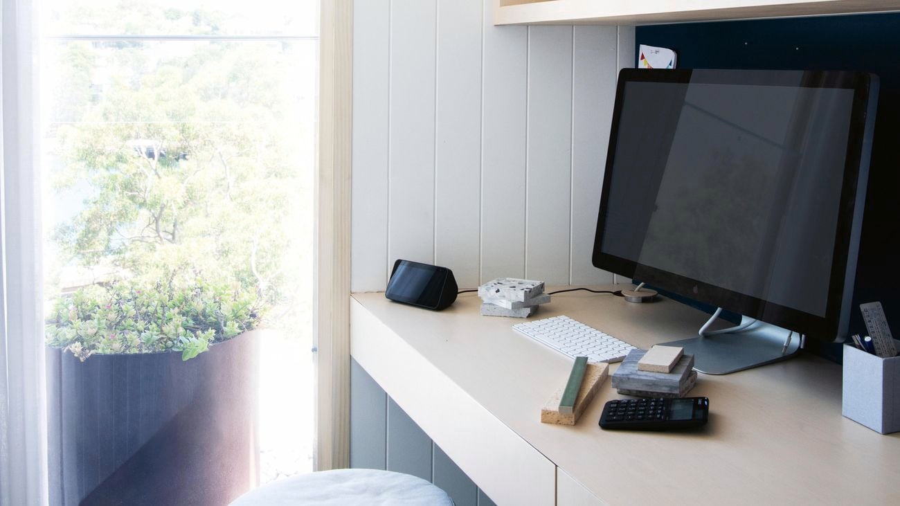 Home office with chair, desk, computer and window to garden