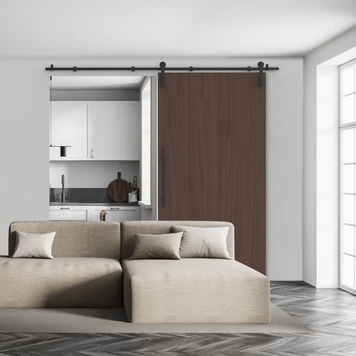 Living room interior featuring Rolltrak Matte Black Round Side Mount Barn Door Track and 400mm Matte Black Round Single Pull Handle.