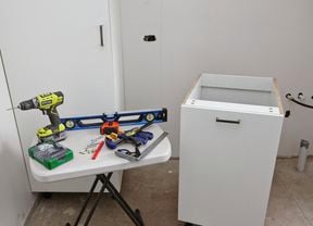 A collection of tools and an assembled laundry chute