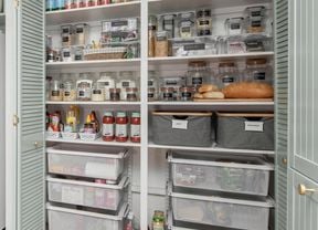 Pantry with items neatly organised and baskets for additional storage.
