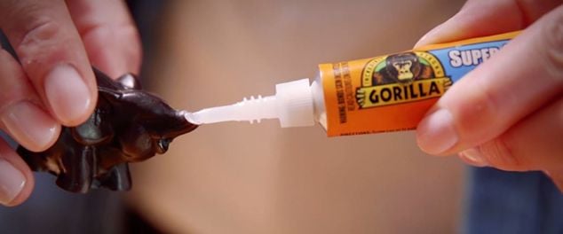 Superglue being used to mend a small statuette