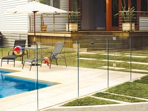 pool fencing around inground pool with sun chairs