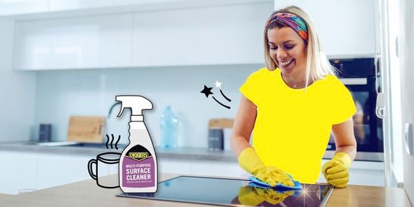 Woman in yellow tee cleaning the stove with Diggers