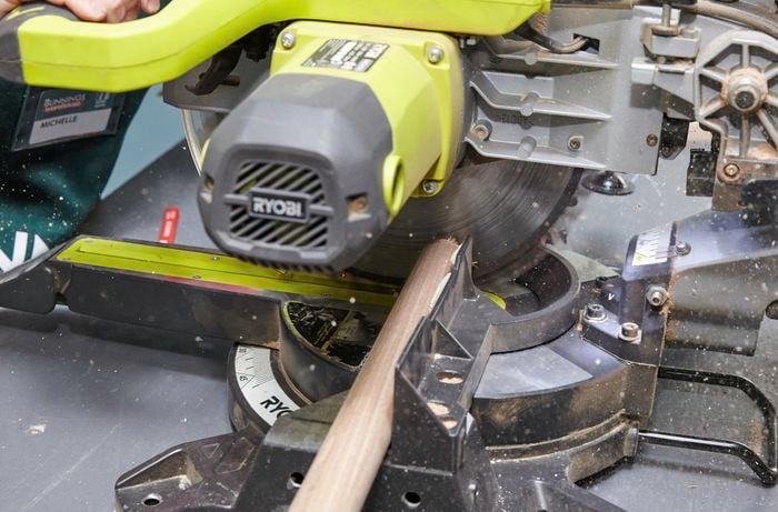 Person cutting timber for bedhead using circular saw
