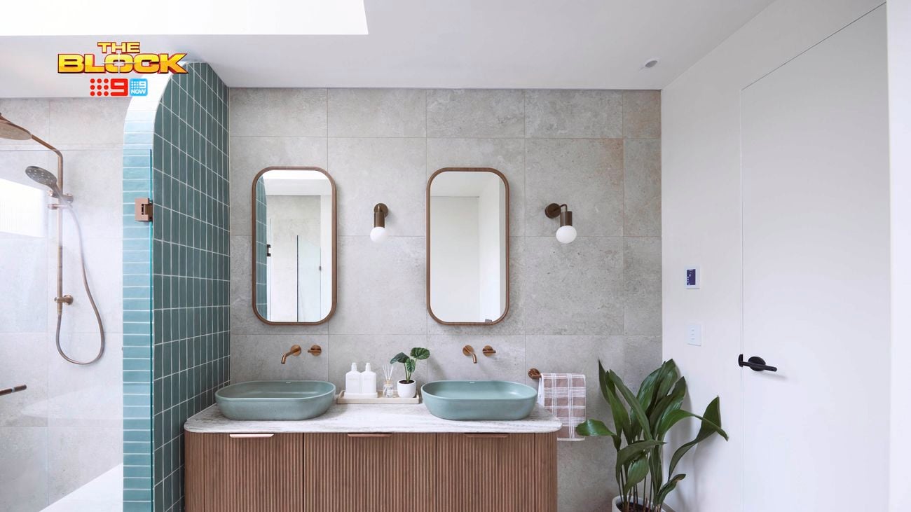 Blue and white bathroom with blue oval basins on a brown timber vanity with a fluted profile