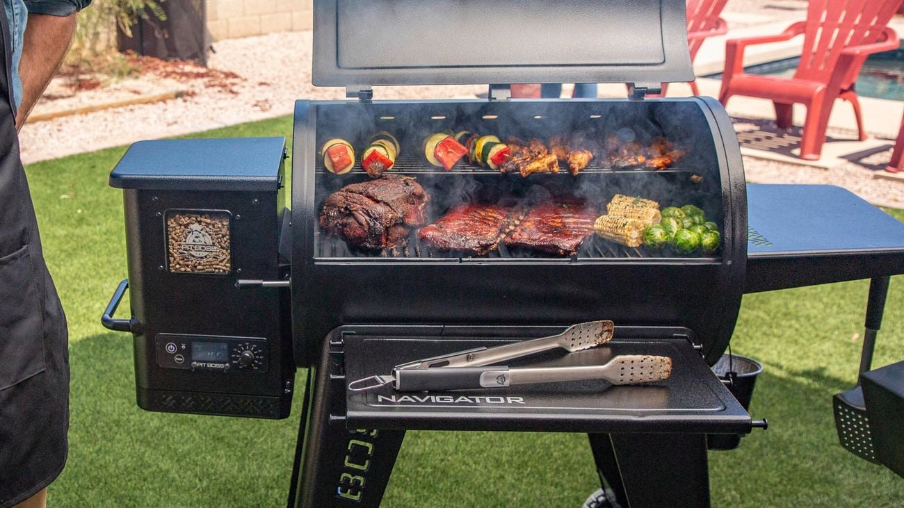 Pit Boss BBQ in yard with food cooking