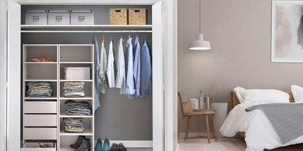 A wardrobe in a bedroom next to a bed