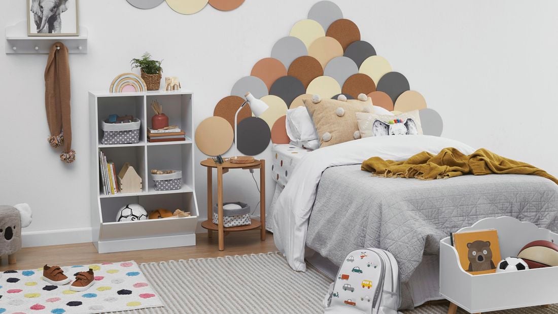 Kids bedroom with colourful bedhead, cube storage and lots of toys.