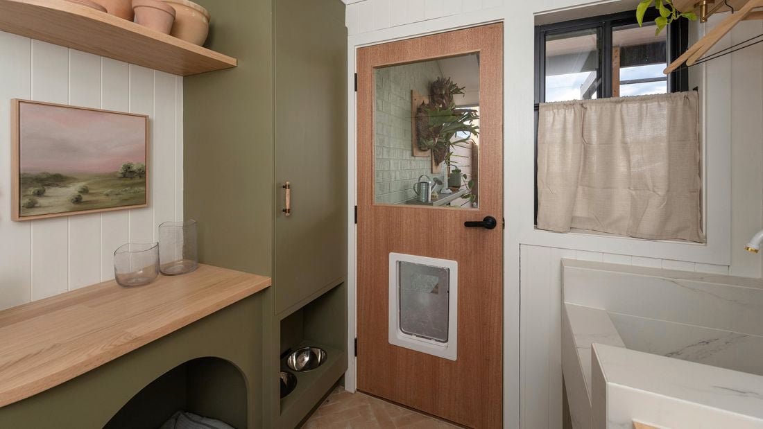 A pet door in a laundry door, in a laundry