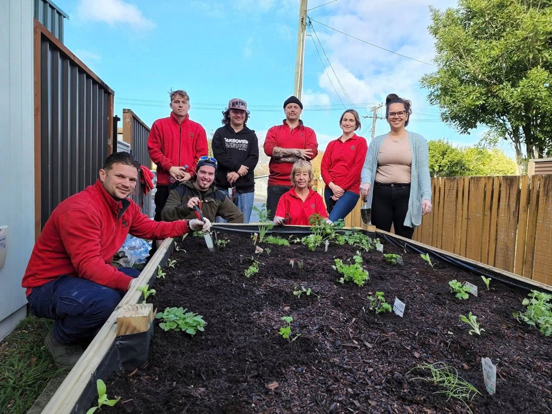 Bunnings Team Members and people around a vegetable garden